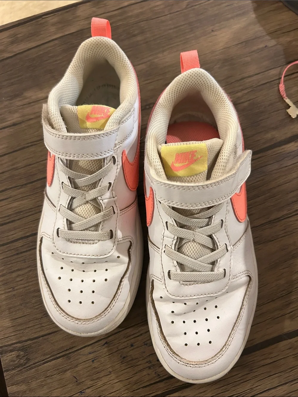 Nike Kids White Sneakers with Coral Swoosh and Yellow Tongue